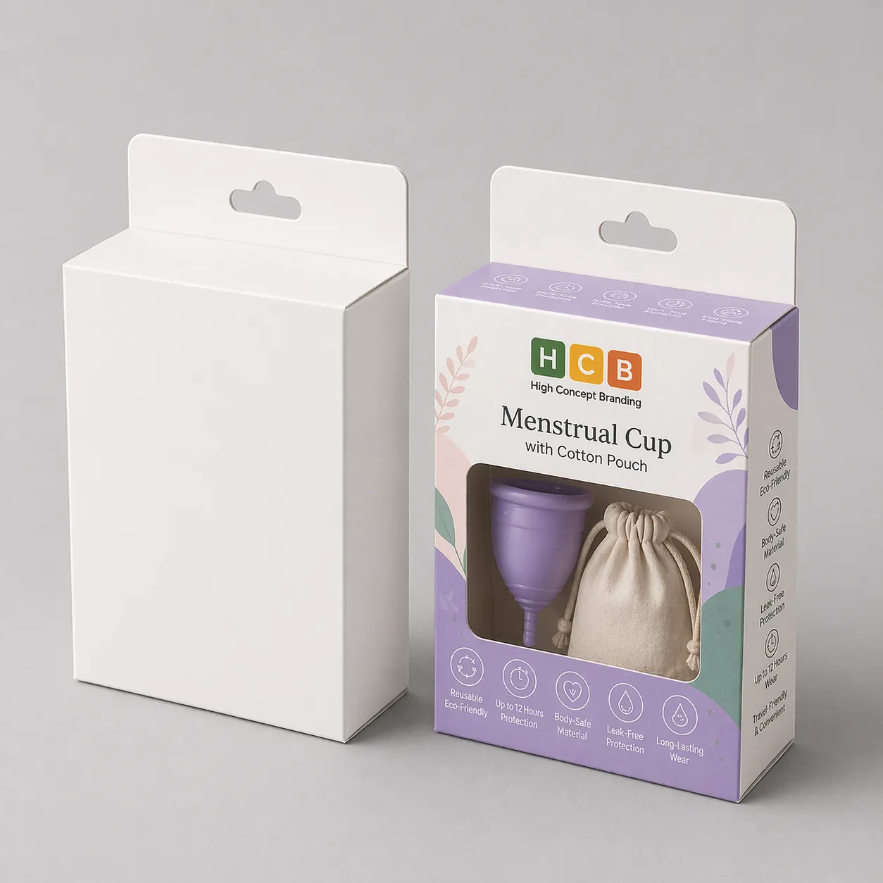 A white retail box standing next to a branded pink box featuring menstrual cup product details. class=